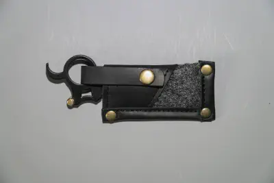 A mini straight razor with swappable blade and finger ring in a case